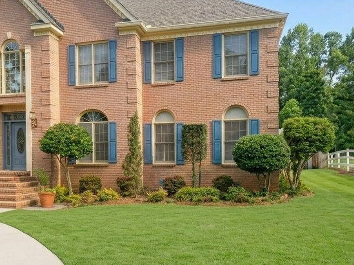 Two story brick home, front beds and lawn brought back, after