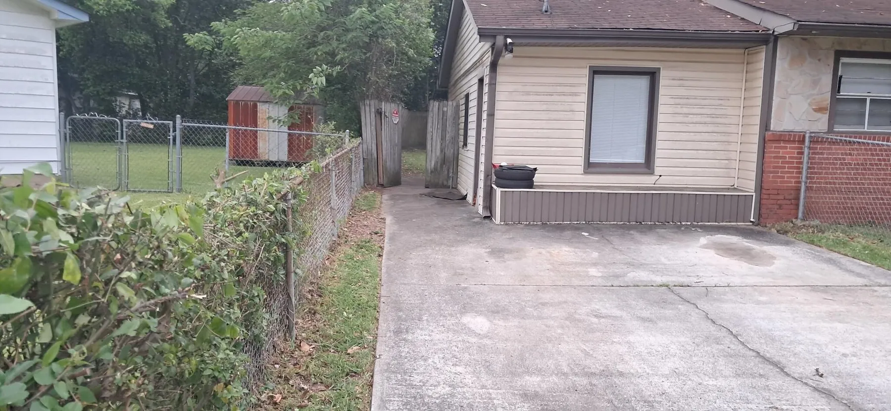 Driveway and carport area cleared of overgrowth