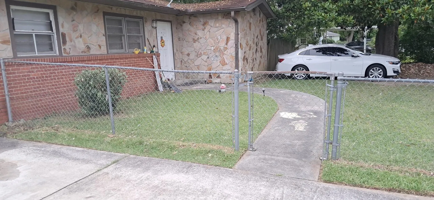 Brick home with driveway and lawn edges cleaned up