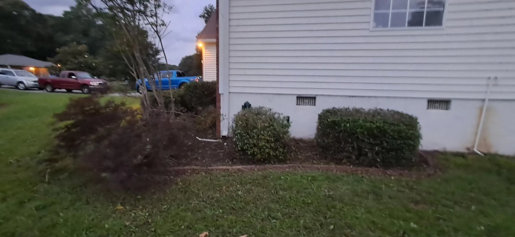 Shrub beds trimmed back along a home