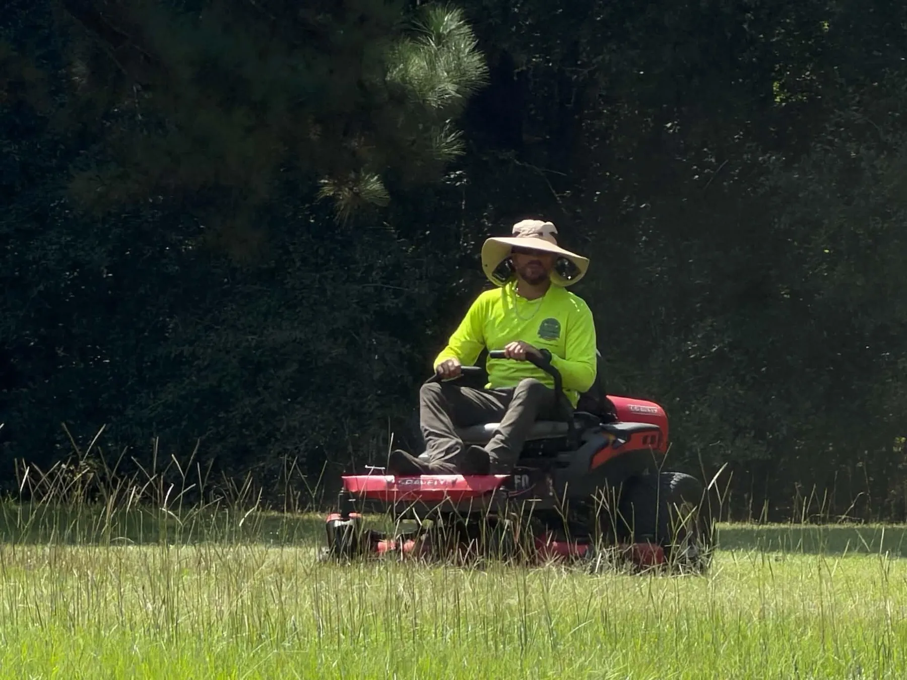 Mowing down tall grass on a hot afternoon